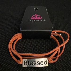 Orange cord “Blessed” bracelet.